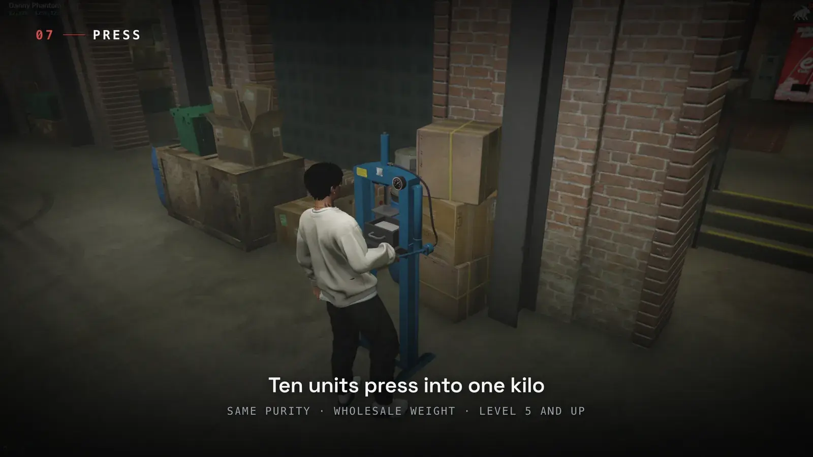 Player working a blue hydraulic Brick Press placed against a brick wall beside stacked boxes