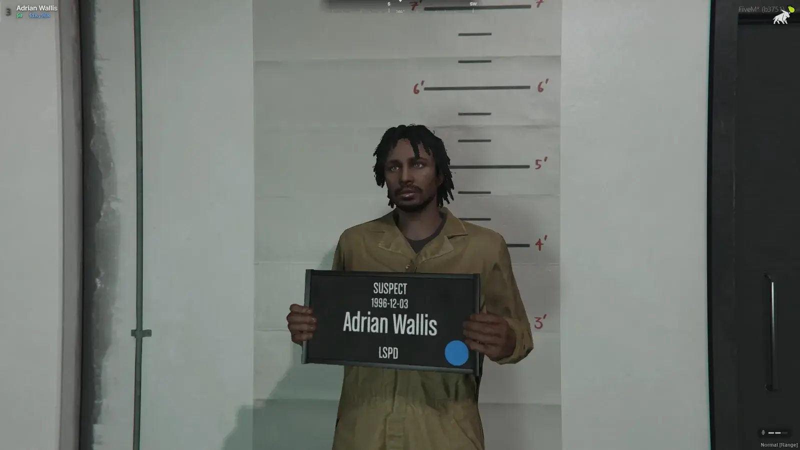 Suspect holding a booking placard in front of a height chart during mugshot capture