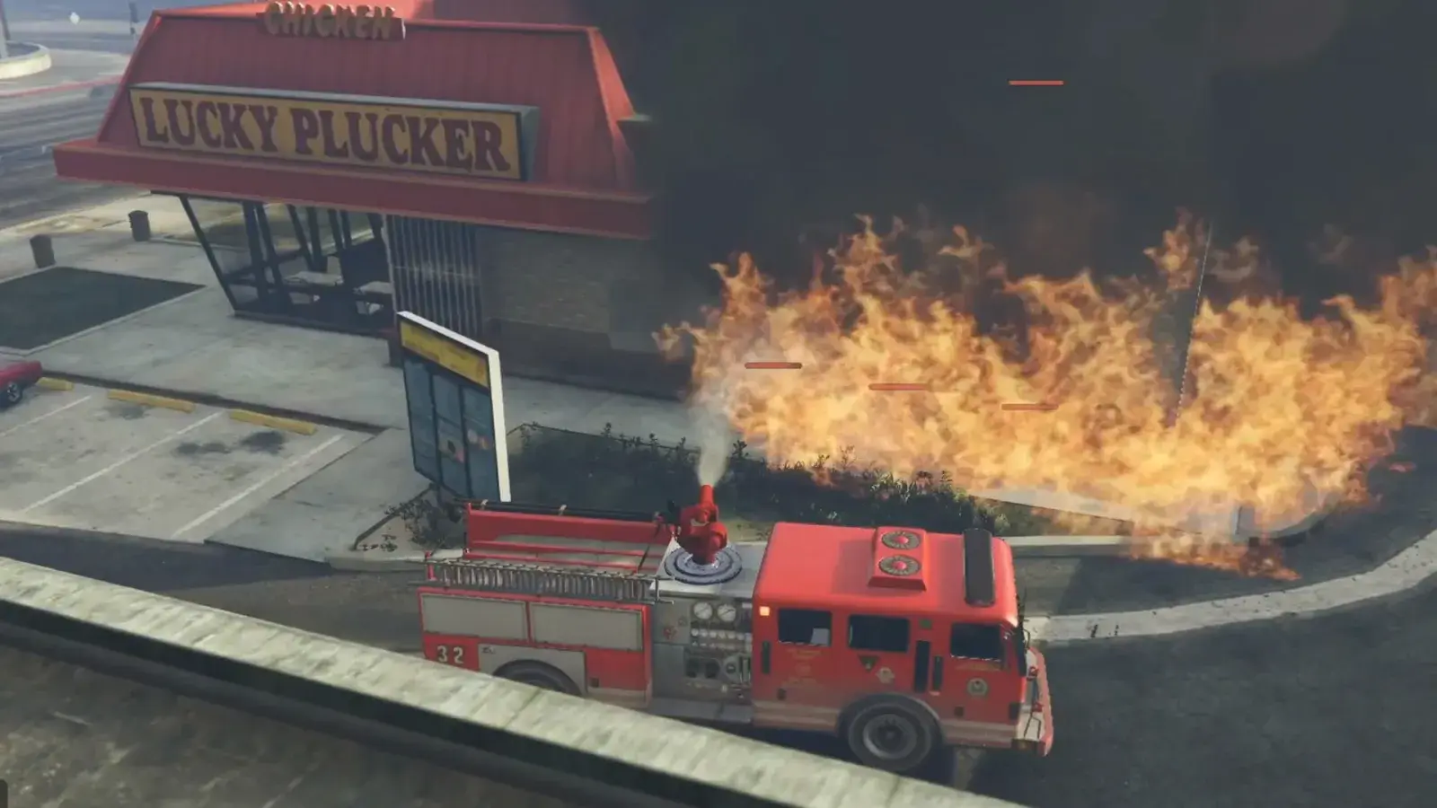 A red fire engine parked in front of a burning restaurant, its roof cannon spraying the flames