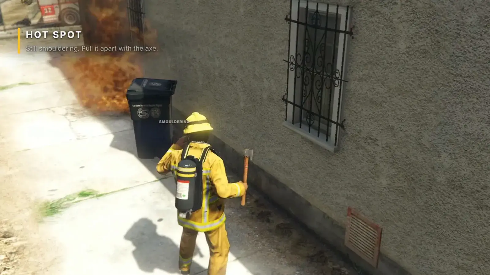 A firefighter swings an axe at a smouldering bin beside a house, with the Hot Spot card top left
